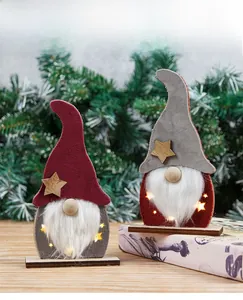 Detail of light-up Christmas gnome with warm LED glow and rustic wooden star ornaments