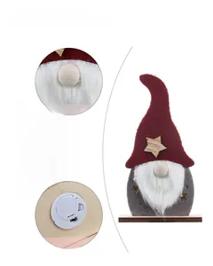 Detail views of wooden Christmas gnome with LED lights and felt hat decoration