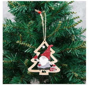 Close-up of wooden Christmas gnome ornament hanging on a pine tree with rustic rope