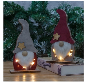 Macro detail of lighted Christmas gnome gnomes with warm LED stars on wooden base