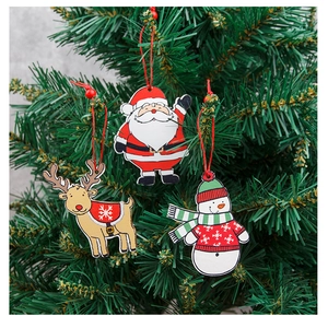 Detailed view of hand-painted wooden Christmas ornaments hanging on a green tree branch