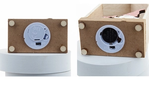 Detail view of the battery compartment and ON/OFF switch for LED wooden Christmas house