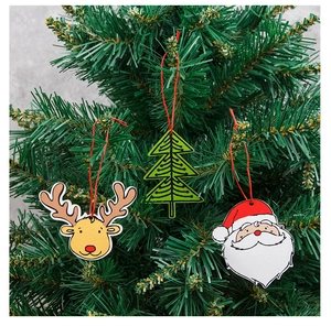 Close-up of reindeer, Christmas tree, and Santa Claus wooden hanging ornaments on branches