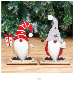 Detail of wooden Christmas gnomes with plush beards and hand-painted festive symbols