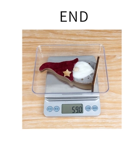Detailed view of a light-up Christmas gnome decoration weighing exactly 59 grams