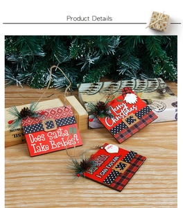 Detailed view of red wooden Christmas tree ornaments with pine cones and festive patterns