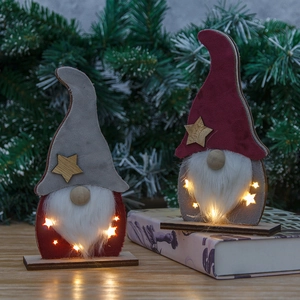 Lighted Christmas gnome ornaments with warm LED glow and wooden star details