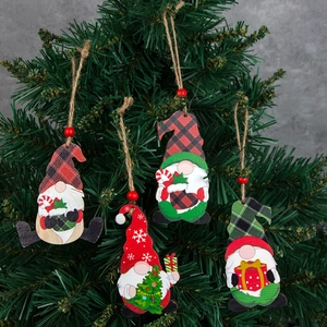 Set of 4 festive wooden gnome ornaments hanging on a Christmas tree branch