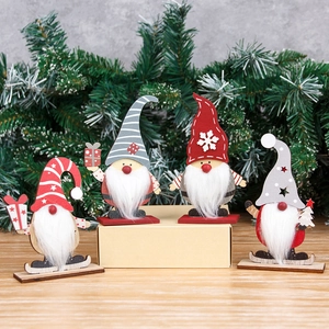 Set of four wooden Christmas gnomes with white fiber beards and festive striped hats