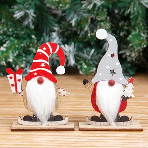 Wooden Christmas gnome figurines with striped hat and star cutout on a festive table