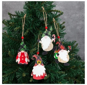 Set of 4 Christmas wooden gnome ornaments hanging on a green tree with red beads