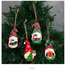 Detail of 4-piece set Christmas gnomes wooden pendants hanging on a Christmas tree
