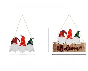 Detail view of two Christmas gnome wooden hanging signs with plaid hats and Welcome text