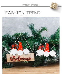 Close-up of wooden Christmas gnome welcome sign hanging on festive tree branches