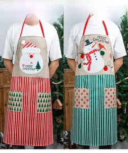 Close-up of Christmas aprons featuring Santa and Snowman embroidery with pockets
