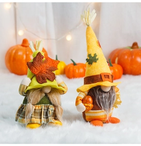Close-up of autumn gnomes featuring maple leaves, acorns and cozy fall textures
