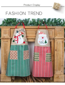 Detail of Christmas striped aprons with Santa and Snowman patterns on rustic fireplace