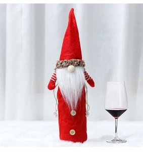 Detailed view of red Christmas gnome wine bottle cover with white beard and felt hat decor