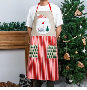Detail of Christmas apron featuring Santa applique, red stripes, and dual front pockets