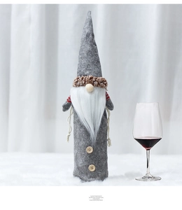 Detail of grey felt Christmas gnome wine bottle cover with white beard and wood buttons