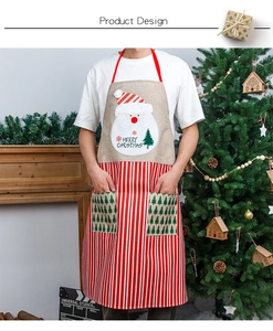 Detail of Christmas apron featuring Santa Claus print, red stripes, and dual front pockets