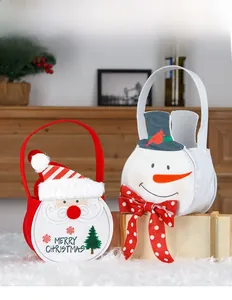 Close-up of Santa and Snowman felt gift bags with plush trim and Merry Christmas print
