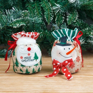 Christmas burlap drawstring gift bags with Santa and Snowman on a wooden background