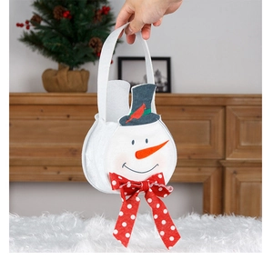 Detail of felt snowman Christmas gift bag with polka dot bow and wide handle grip