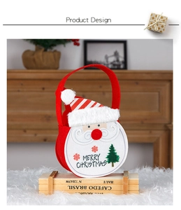 Detail of felt Christmas gift bag featuring Santa Claus face and Merry Christmas text
