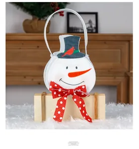 Detail view of snowman Christmas gift bag with red bow and black hat decoration