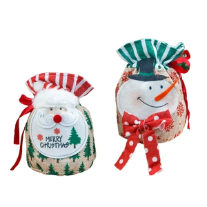 Christmas burlap gift bags featuring Santa and Snowman designs with red ribbon drawstrings