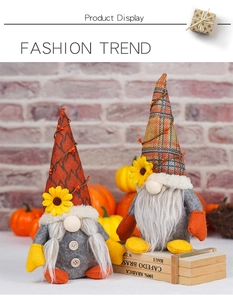 Detailed view of autumn harvest gnomes with sunflowers and plaid hats in fall setting