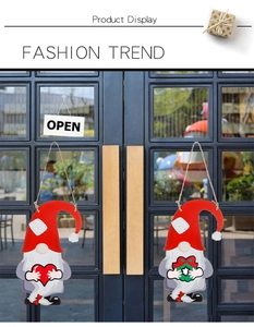 Detail of DIY wooden Christmas gnomes door signs with heart and wreath for holiday decor