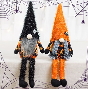 Close-up of Halloween faceless gnomes with sequined hats and pumpkin pattern outfits