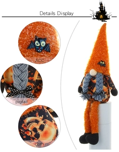 Detail display of Halloween gnome with orange plush hat, bat accents, and skull patterns