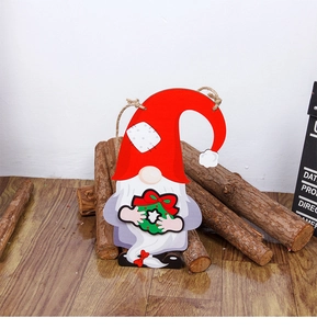 Detailed view of DIY wooden Christmas gnome door hanger with a green festive wreath and twine
