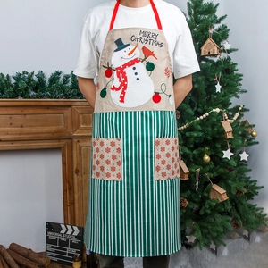 Christmas snowman apron with green stripes and pockets in a cozy festive setting