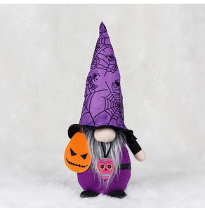 Detailed close-up of a Halloween gnome plush with spider web hat and pumpkin decor