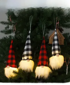Hanging Christmas gnome night lights with plaid hats on a pine tree for festive decor