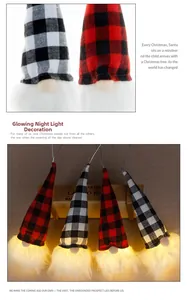 Close-up of glowing Christmas gnomes with plaid hats and warm LED lights for holiday decor