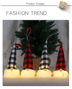 Detail of four lighted Christmas gnomes with plaid hats and warm LED glow for holiday decor