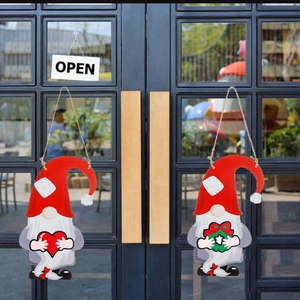 DIY Christmas gnome wooden door signs with heart and wreath on a black glass door