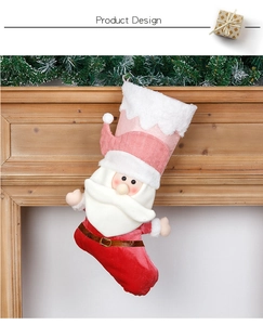 Detail of 3D Santa Claus Christmas stocking with pink sequins and red velvet hanging on mantle