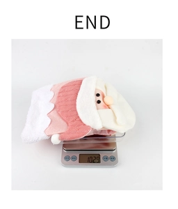 Detailed view of a pink plush Christmas stocking decoration weighing 102.9g on a digital scale