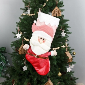 Pink 3D Santa Claus Christmas stocking gift bag hanging on a decorated tree