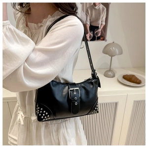 Close-up of black leather underarm bag with silver square buckle and rivet details