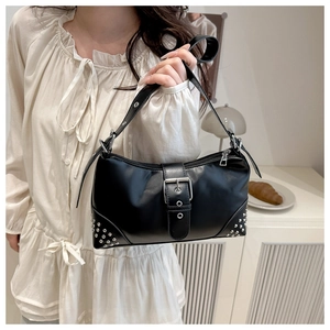 Close-up of black PU leather shoulder bag with silver studs and belt buckle detail