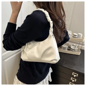 Detail of white pleated hobo bag with pearl chain and fashion strap on shoulder