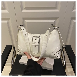 Detailed view of white shoulder bag featuring punk silver buckle and rivet studs decoration