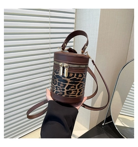 Fashionable leopard print cylindrical bucket bag with leather stitching and gold zippers